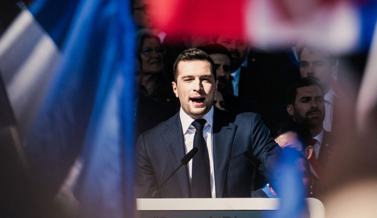 ​Jordan Bardella, president of Rassemblement National or National Rally, gives a speech and flies French flags at a rally in support of Marine le Pen after her conviction on April 6, 2025. 