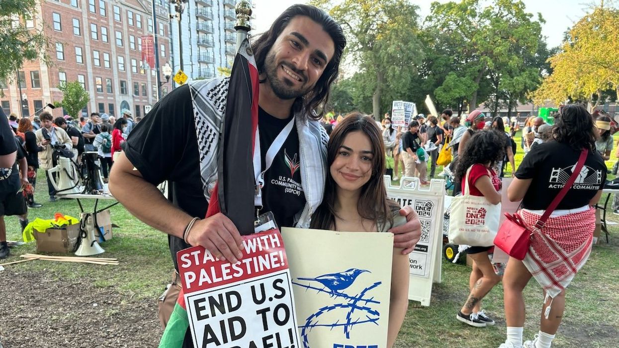 Jousef Shkoukani and his wife, Yara Rashad, join other protesters in Chicago's Union Park on Monday, Aug. 19.
