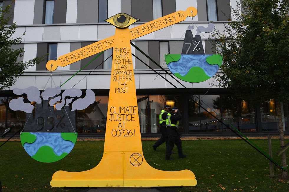 'Justice Scales', an artwork made by Extinction Rebellion activists to illustrate the unequal consequences of climate change near the COP26 venue.