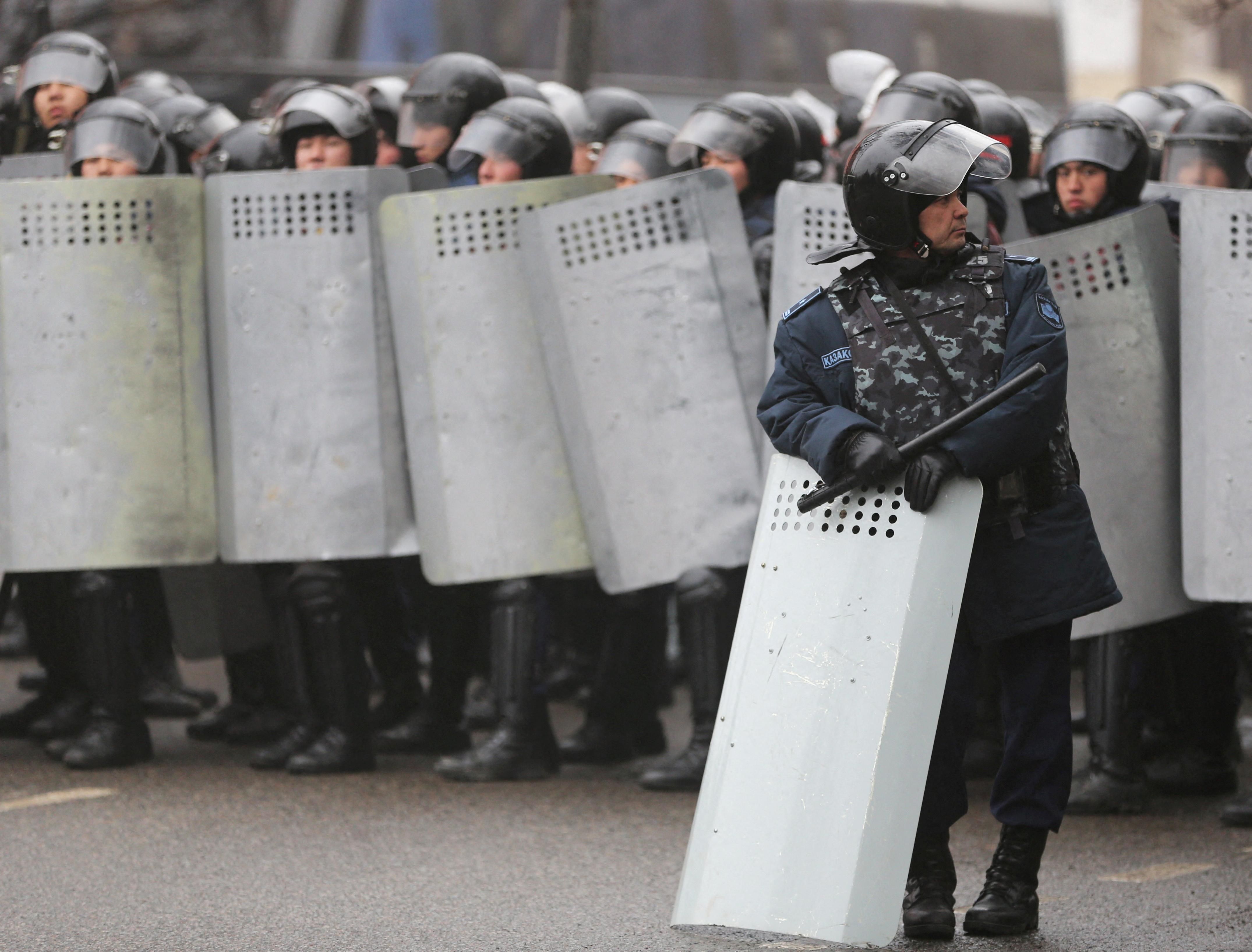 Kazakh law enforcement officers block a street during a protest triggered by fuel price increase in Almaty, Kazakhstan January 5, 2022. 