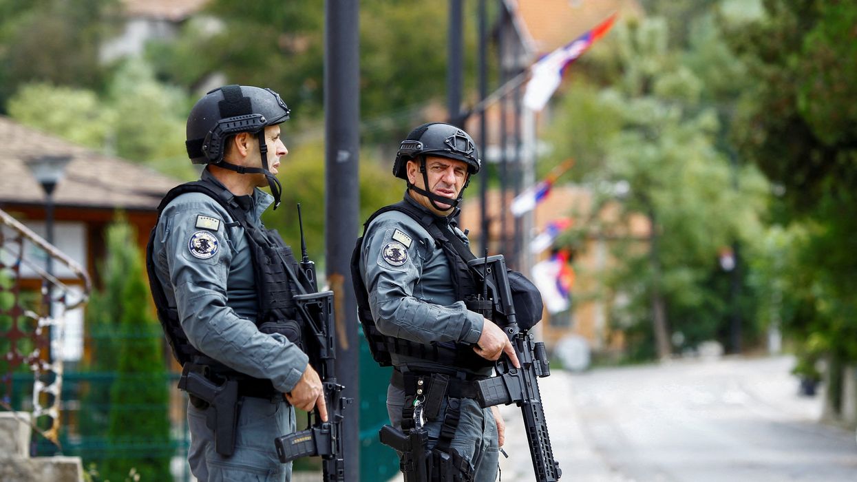 Kosovo police officers patrol, in the aftermath of a shooting incident