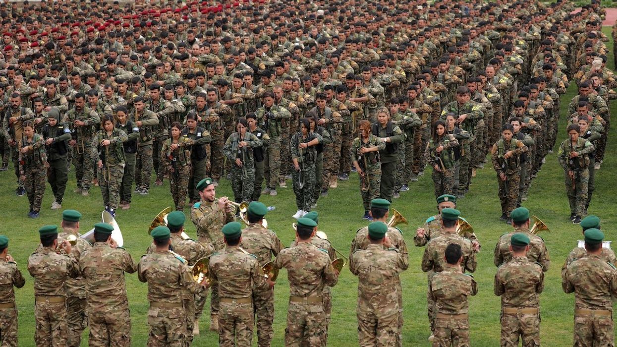 Kurdish fighters from the People's Protection Units (YPG) take part in a military parade as they celebrate victory over the Islamic state, in Qamishli, Syria March 28, 2019.