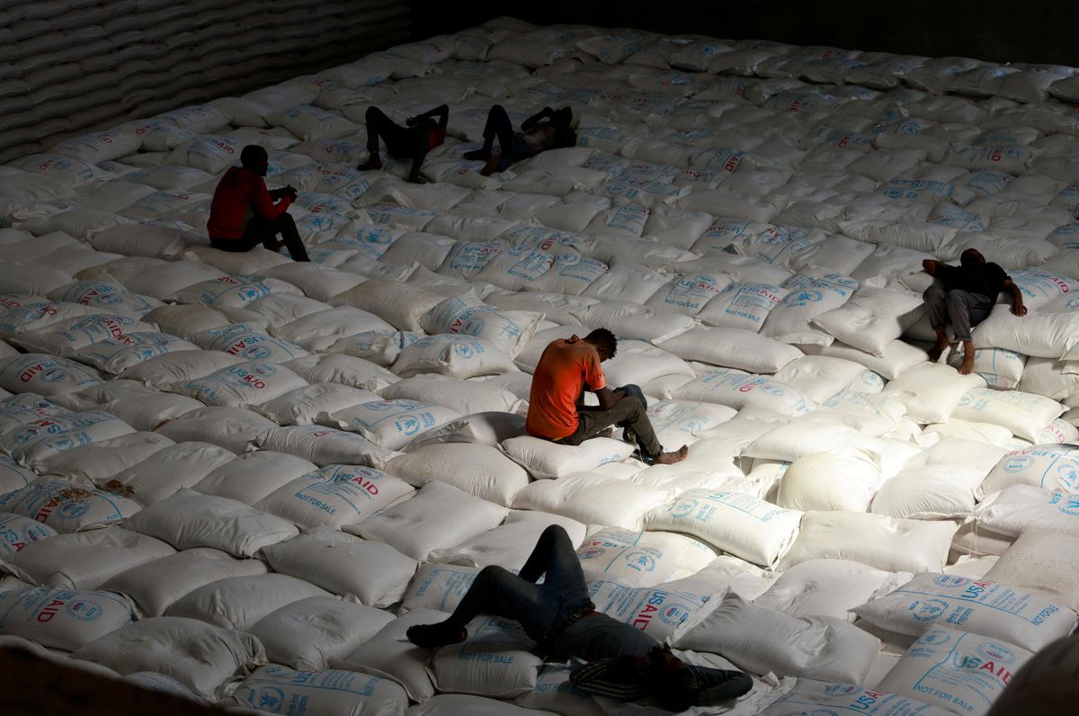 ​Labourers rest as they offload bags of grains as part of relief food that was sent from Ukraine at the World Food Program (WFP) warehouse in Adama town, Ethiopia.