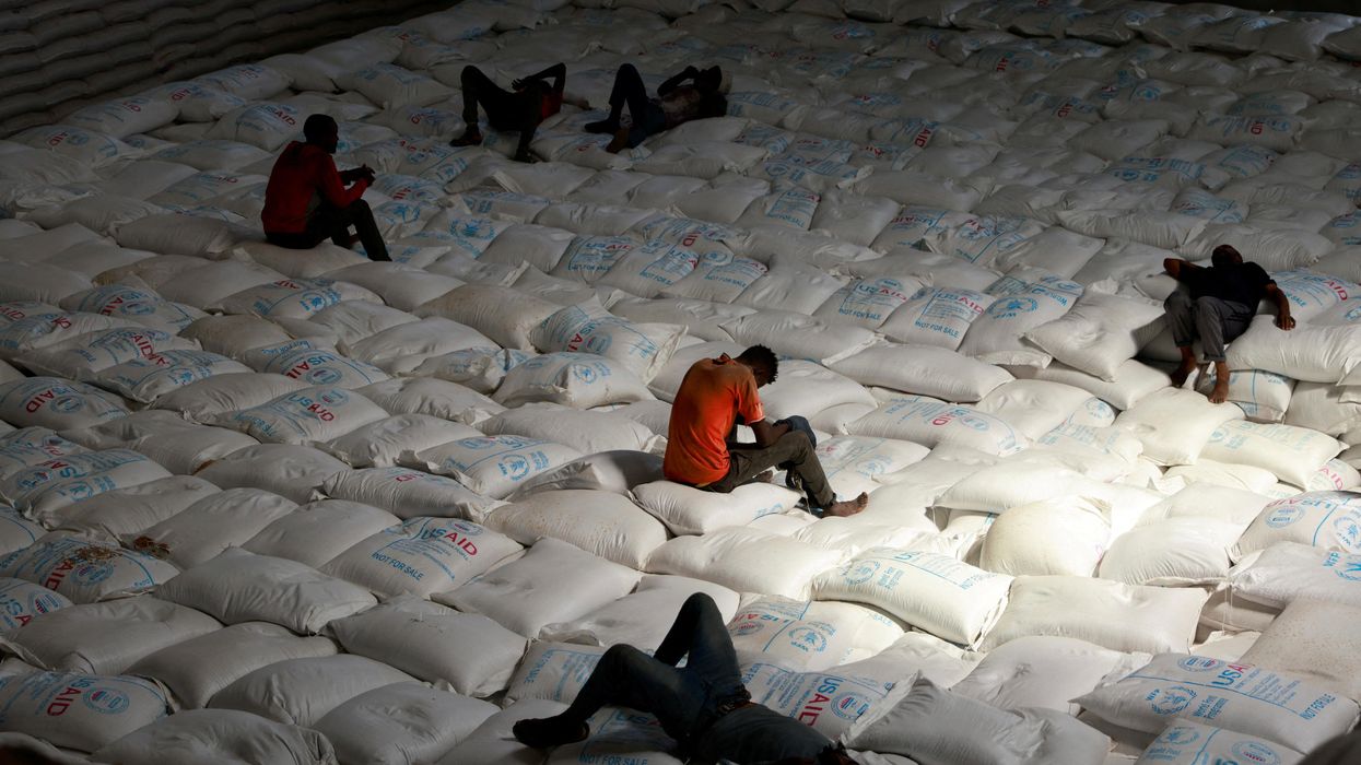 Labourers rest as they offload bags of grains as part of relief food that was sent from Ukraine at the World Food Program (WFP) warehouse in Adama town, Ethiopia.