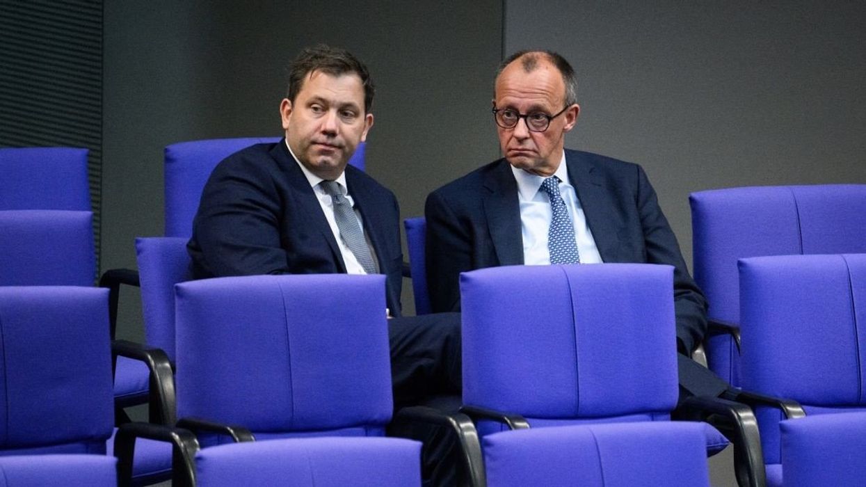 Lars Klingbeil (l), Chairman of the SPD parliamentary group, and Friedrich Merz, CDU Chairman and Chairman of the CDU/CSU parliamentary group, talk at the end of the 213th plenary session of the 20th legislative period in the German Bundestag.