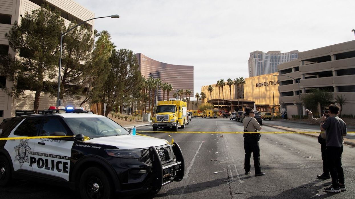 Law enforcement officers stand behind yellow tape in a cordoned area, after a Tesla Cybertruck burned at the entrance of Trump Tower, in Las Vegas, Nevada, on Jan. 1, 2025.