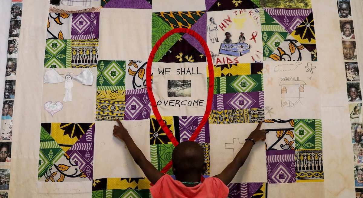 A child plays at an advocacy wall after receiving a dose of antiretroviral ARV drugs used to prevent HIV from replicating, at the Nyumbani Children's Home, which cares for more than 100 children with HIV.