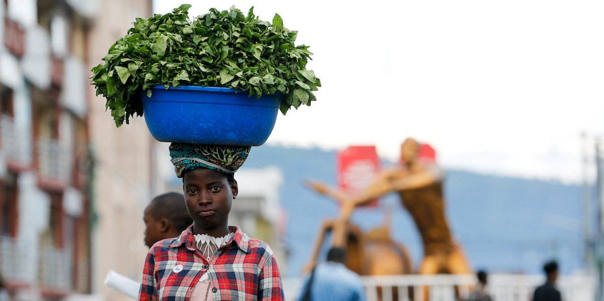 A Congolese girl carries vegetables for sale on the last day of the electoral campaign in Goma, North Kivu province of the Democratic Republic of Congo December 18, 2023.