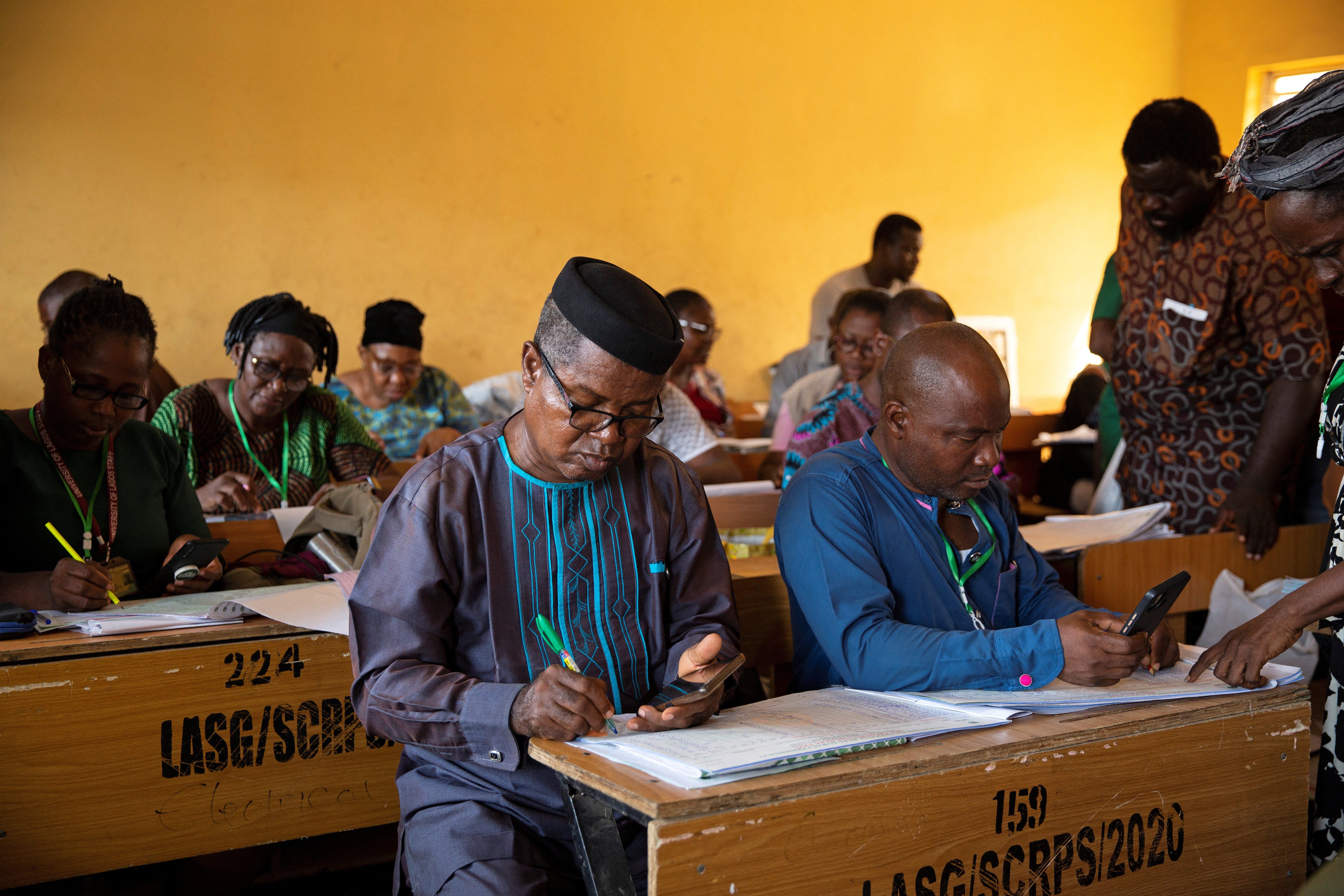 A day after the elections, officials tally votes at a collation centre previously stormed by unknown assailants in Lagos, Nigeria on February 26, 2023.