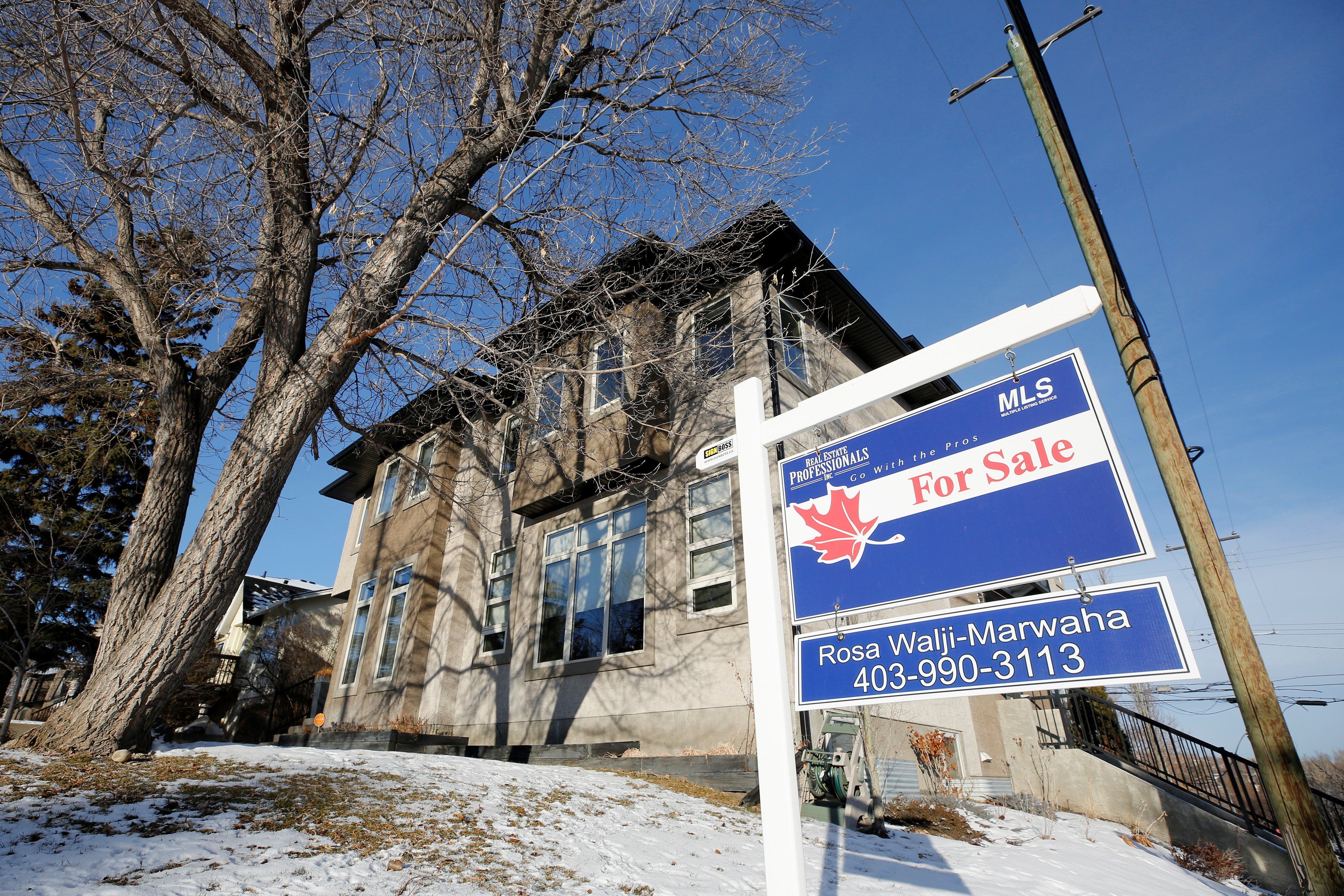 A "For Sale" sign at a house in Calgary, Alberta.