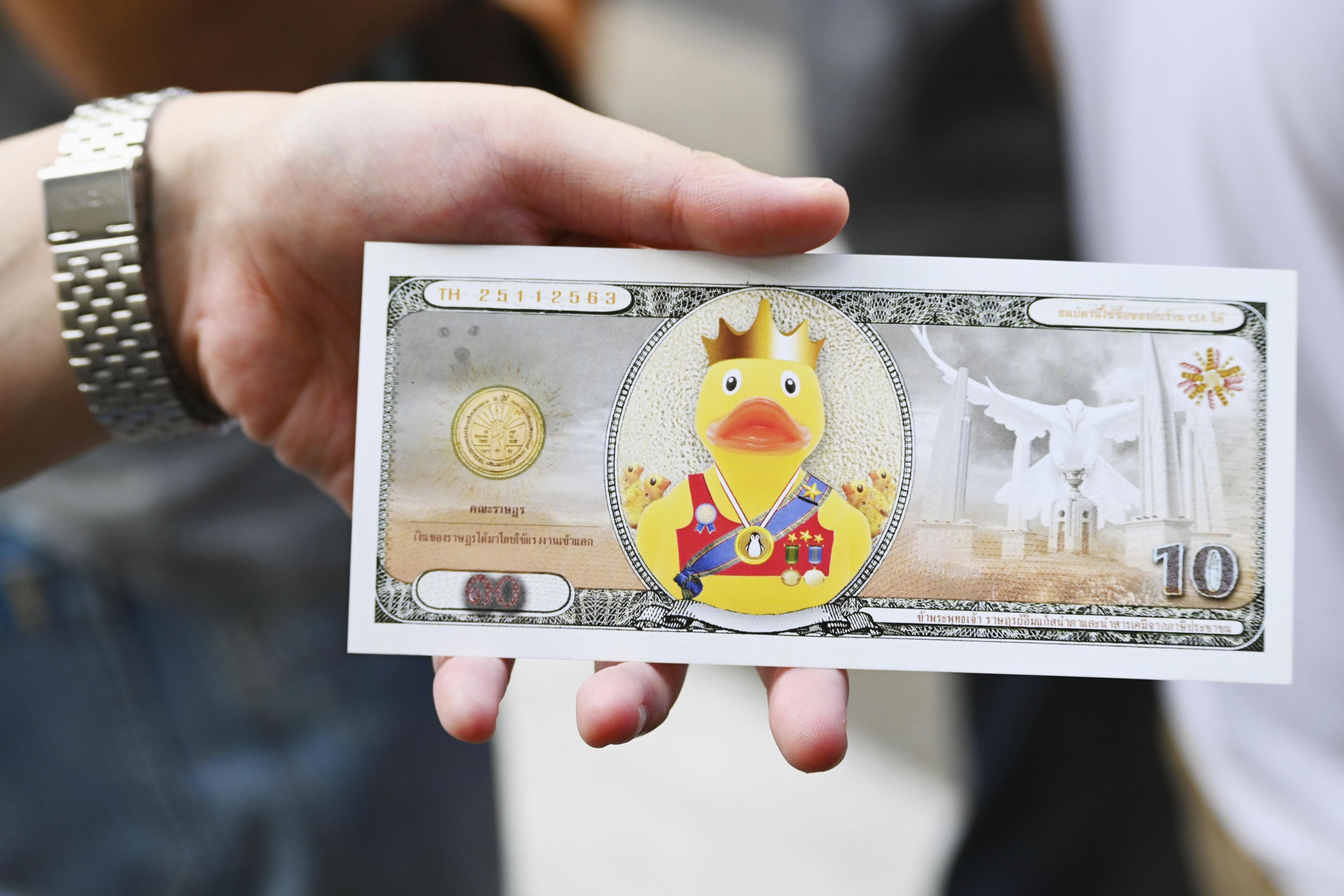 A mock 10 baht banknote bearing an illustration of a yellow duck instead of the Thai king or his predecessor is pictured in Bangkok on Nov. 25, 2020.