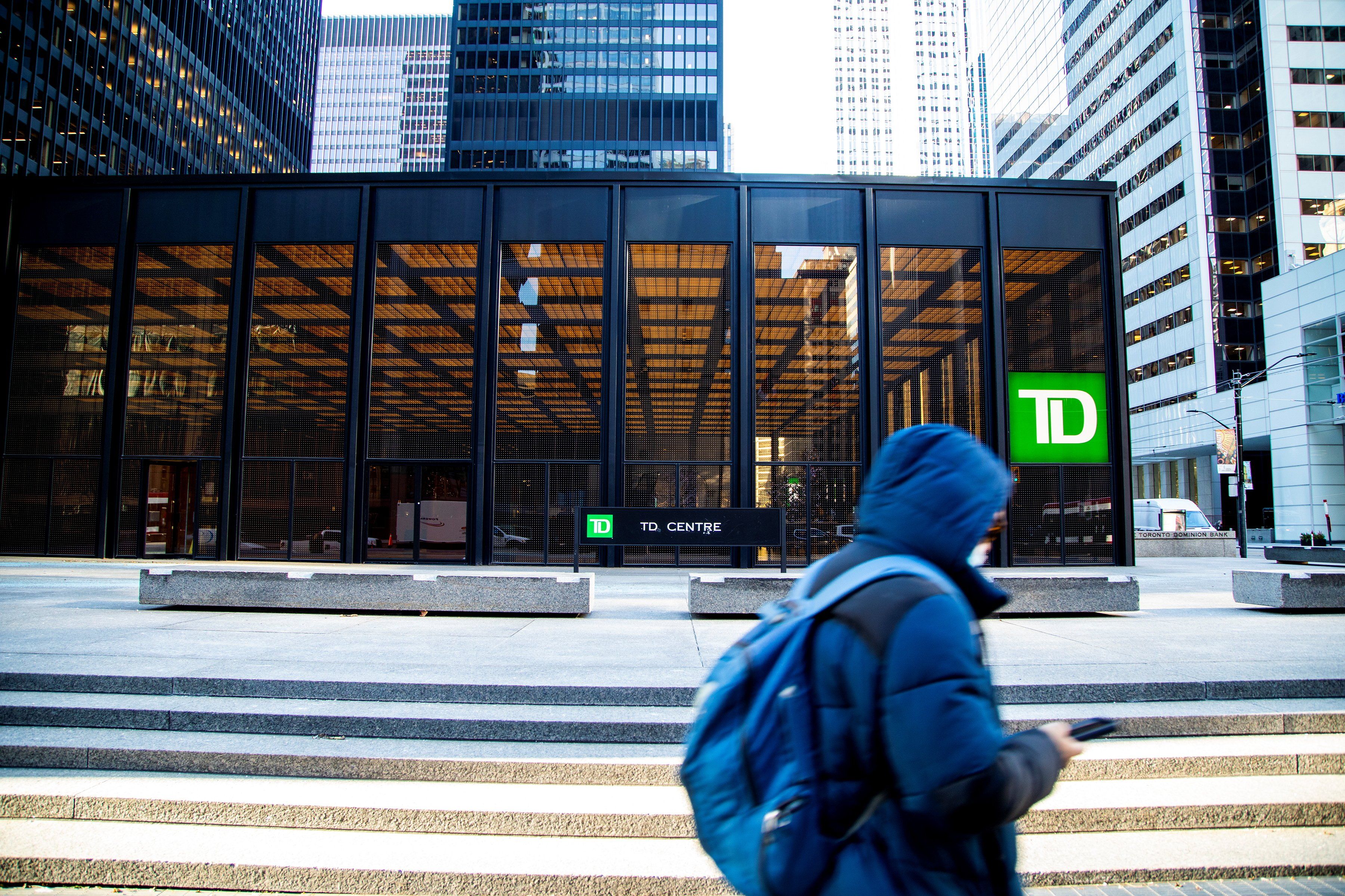 A person walks past a sign for TD Canada Trust in Toronto, Ontario.