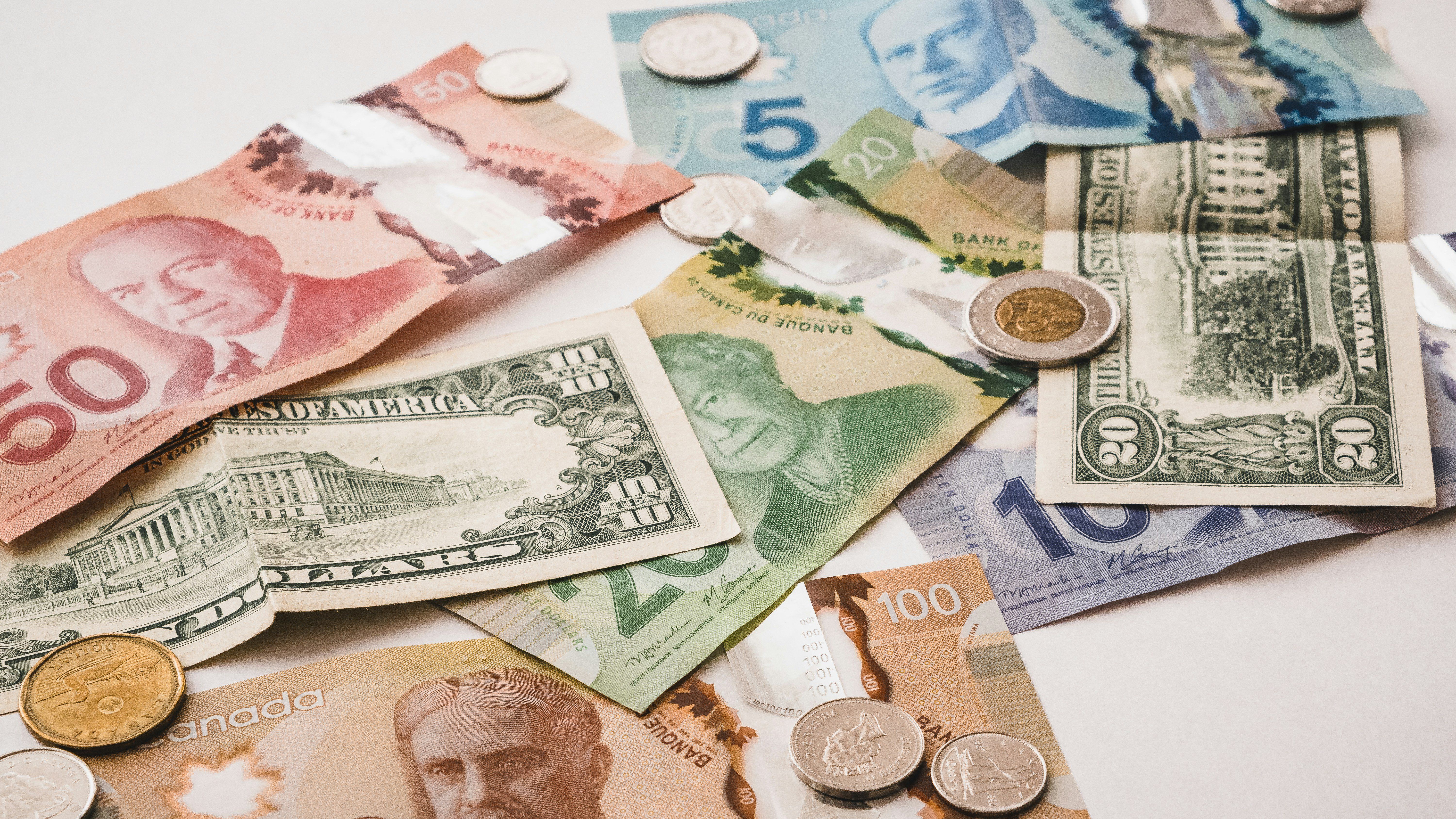 A pile of money sitting on top of a table.