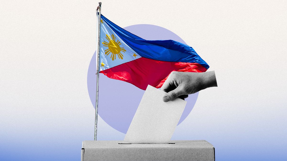 A voter casting a ballot in front of the Philippines flag. 