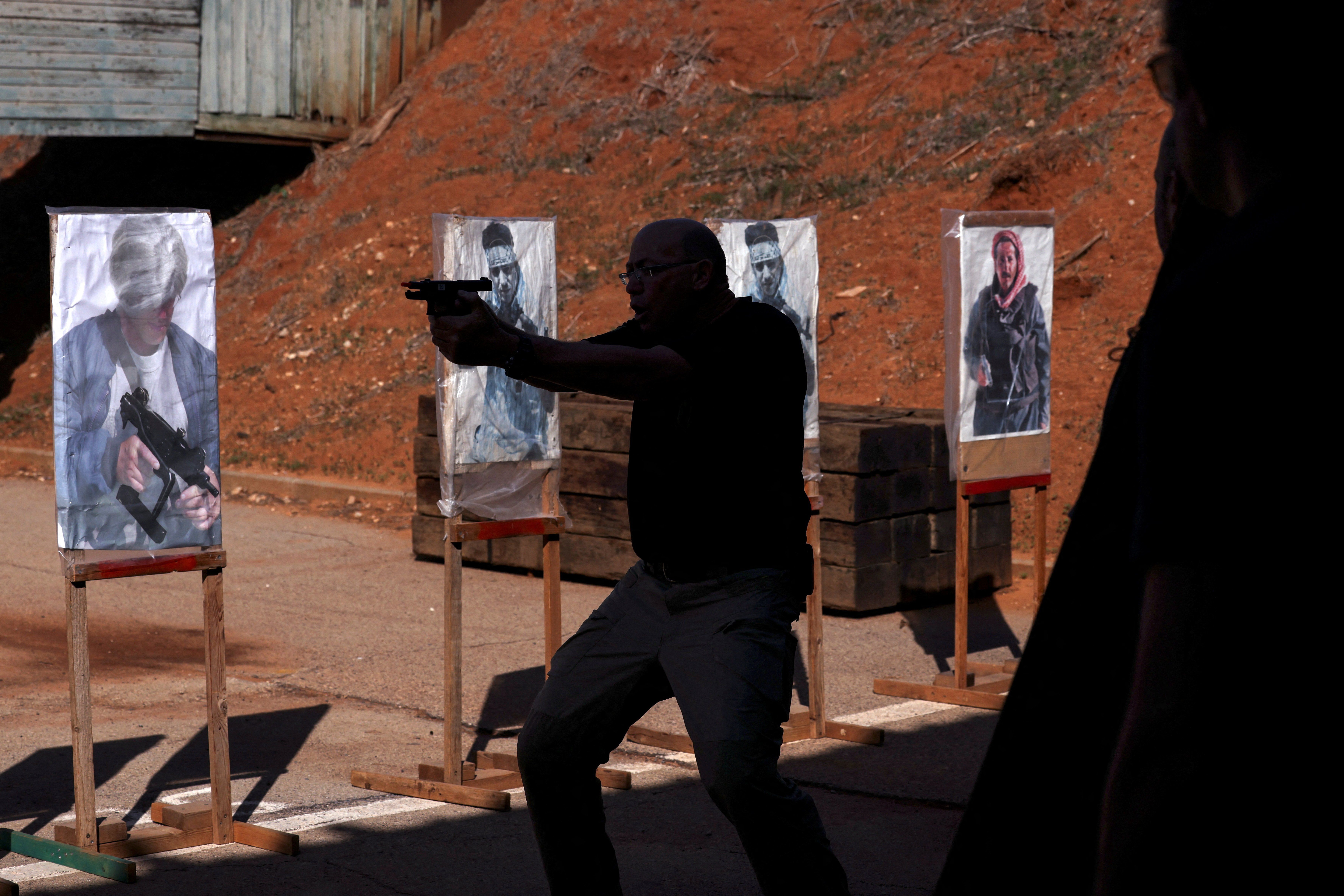 An instructor performs a demonstration during a training session at a shooting range in Kfar Saba, Israel, 
