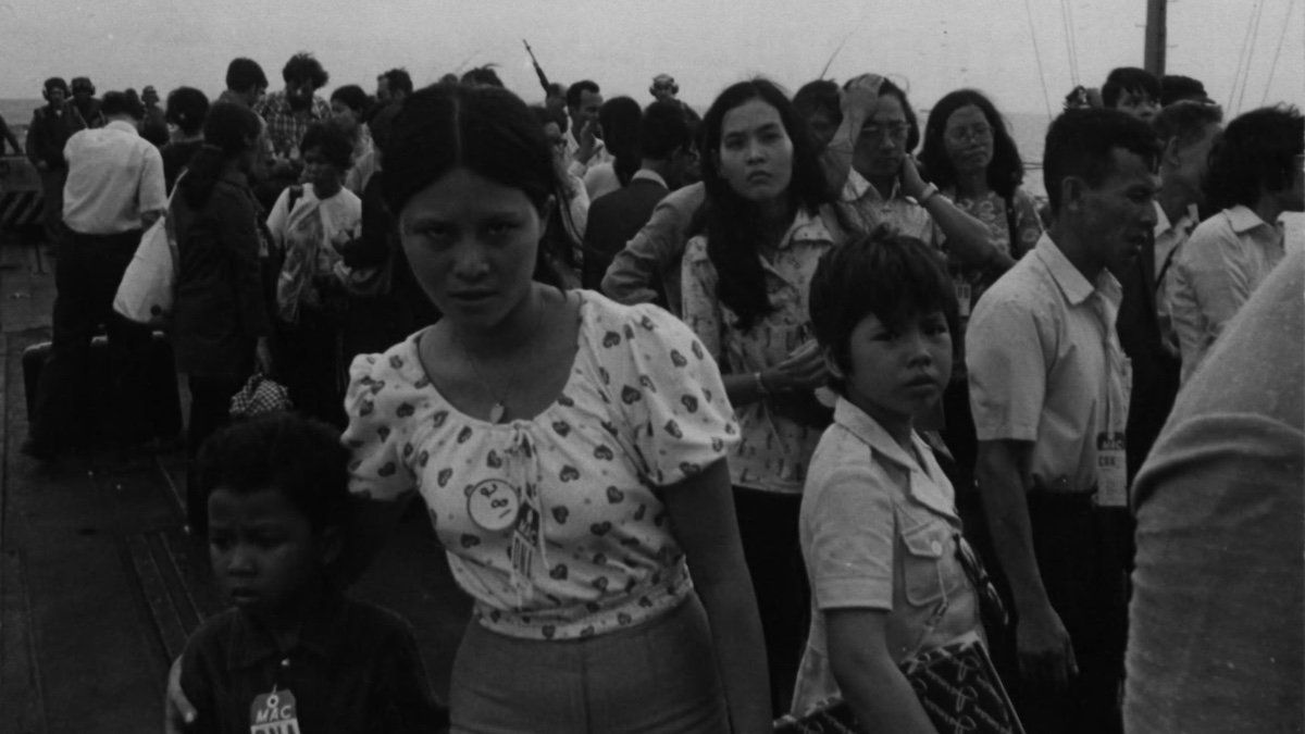 ​April 29, 1975: Vietnamese refugees line up on the deck of USS Hancock for processing following evacuation from Saigon.