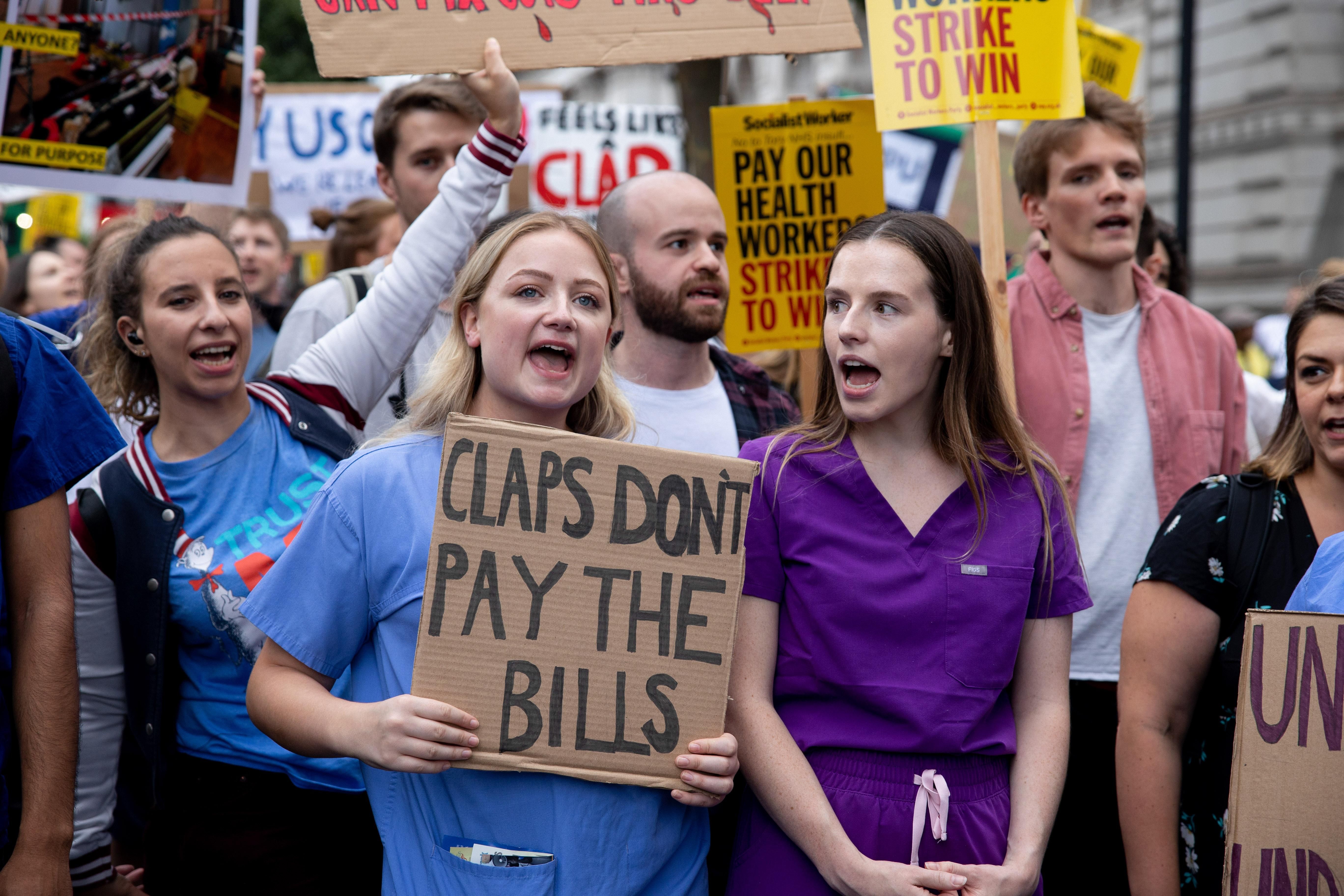 British health workers protest to demand a pay rise outside Downing St. in London.