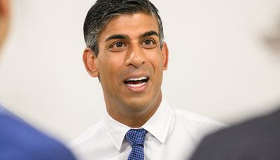British Prime Minister Rishi Sunak speaks to members of staff during a visit to a regional hospital.