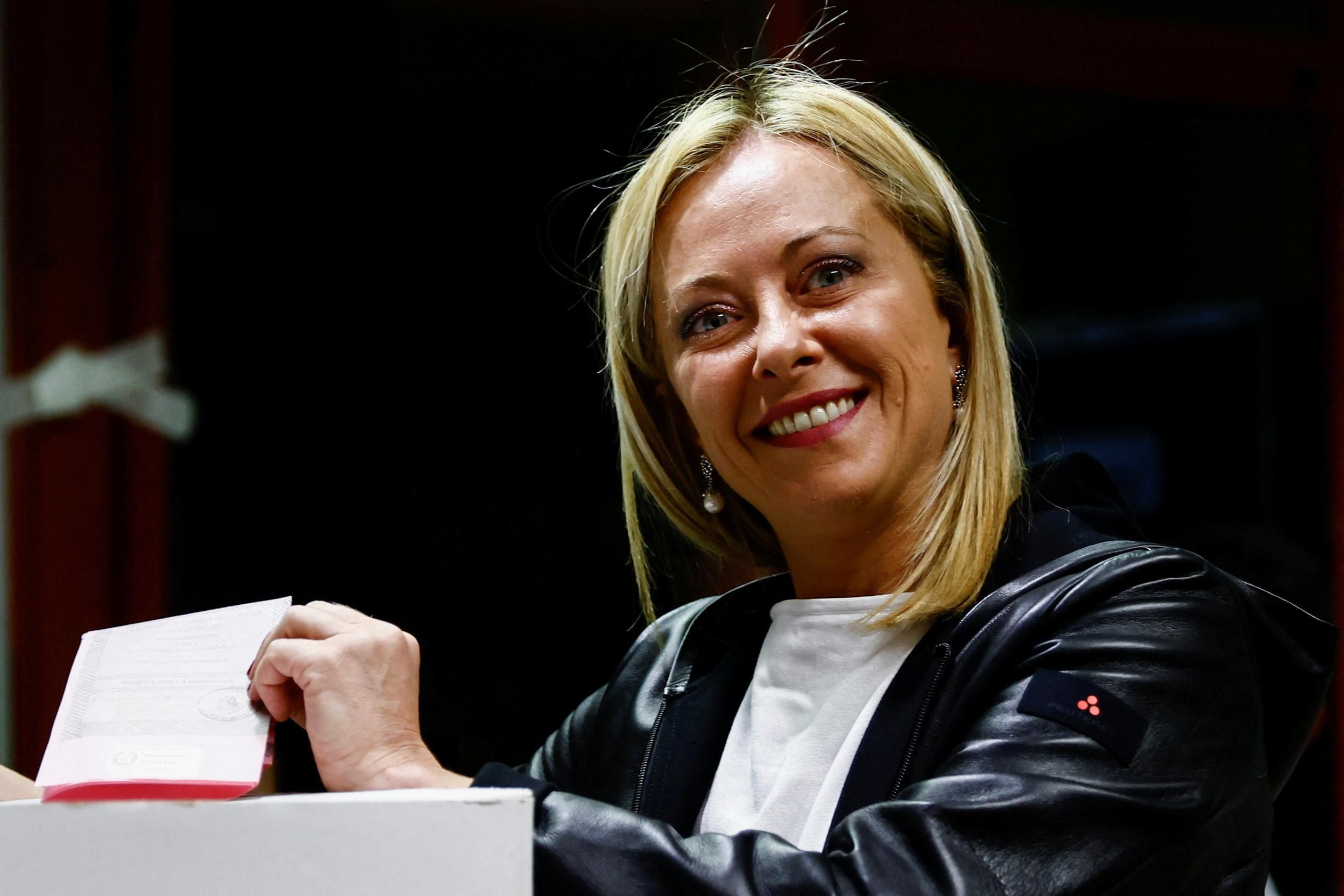 Brothers of Italy leader Giorgia Meloni poses with her ballot at a polling station in Rome. 