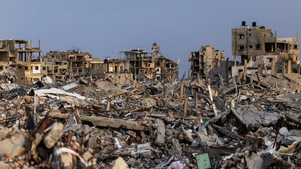 ​Buildings lie in ruins amidst the rubble in Rafah in the southern Gaza Strip, on December 8, 2025.