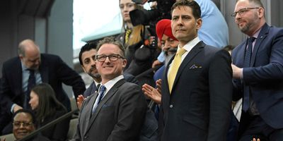 Canadians Michael Kovrig and Michael Spavor stand as they are recognized before an address from US President Joe Biden in the Canadian House of Commons on Parliament Hill, in Ottawa, Canada, March 24, 2023.
