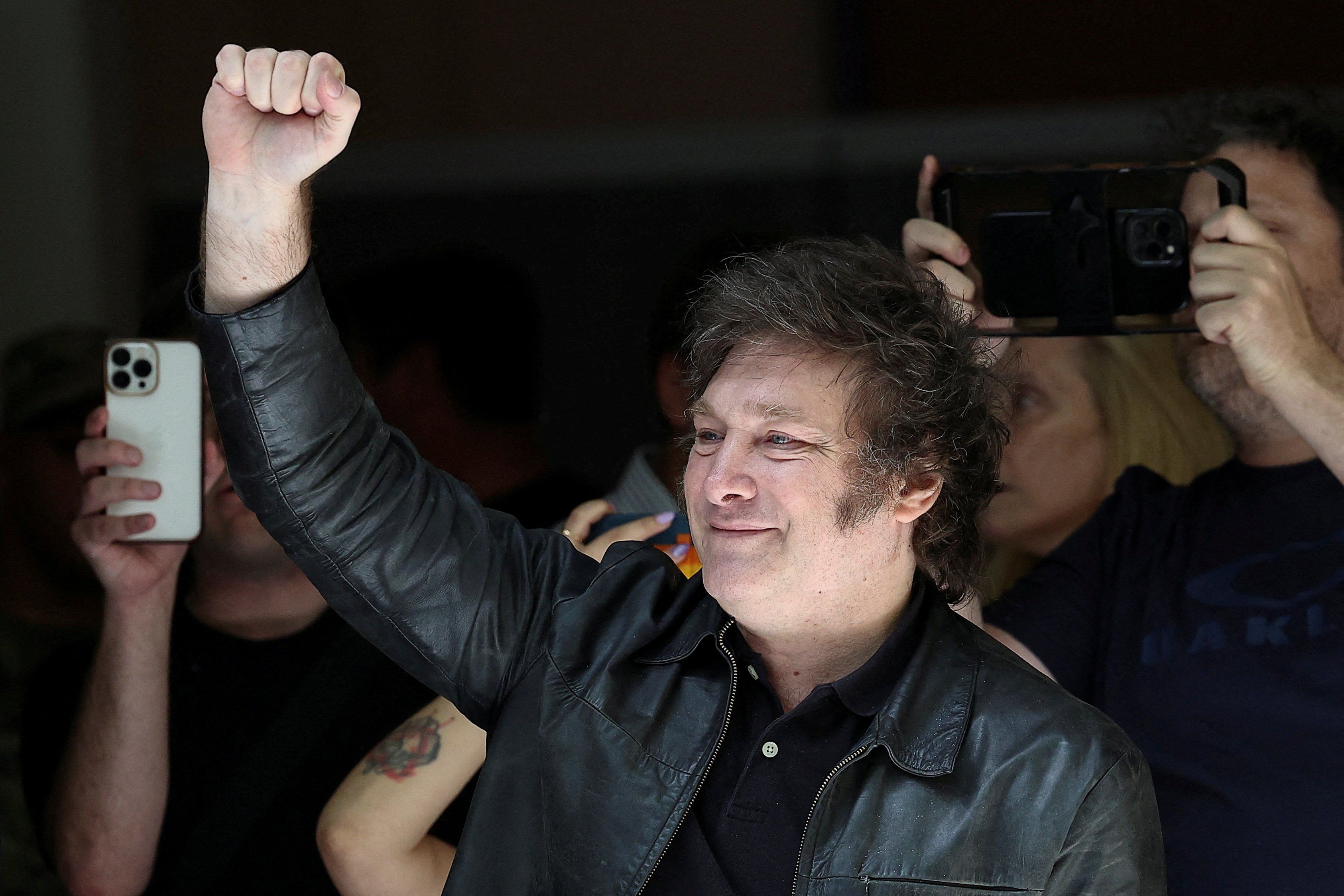 ​Candidate Javier Milei greets his supporters as he arrives at the school where he votes, in Buenos Aires, Argentina, on Nov. 19, 2023. 