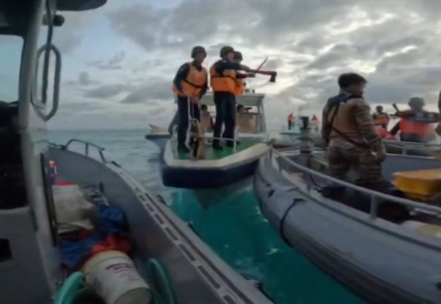 ​Chinese sailors armed with axes and machetes threaten Filipino sailors on a supply run, 17 June, 2024.