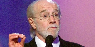 ​Comedian George Carlin speaks after being presented the Lifetime Achievement Award in 2001 at the 15th annual American Comedy Awards in Los Angeles. 