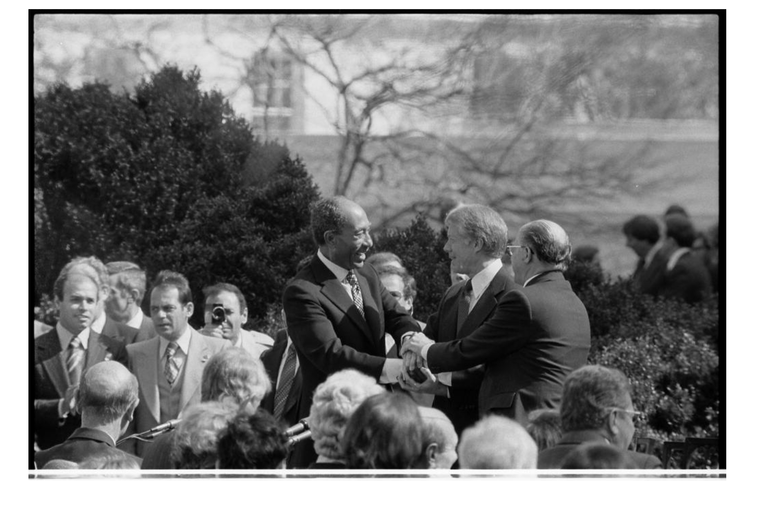 ​Egyptian President Anwar Sadat and Israeli Prime Minister Menachem Begin shaking hands with US president Jimmy Carter