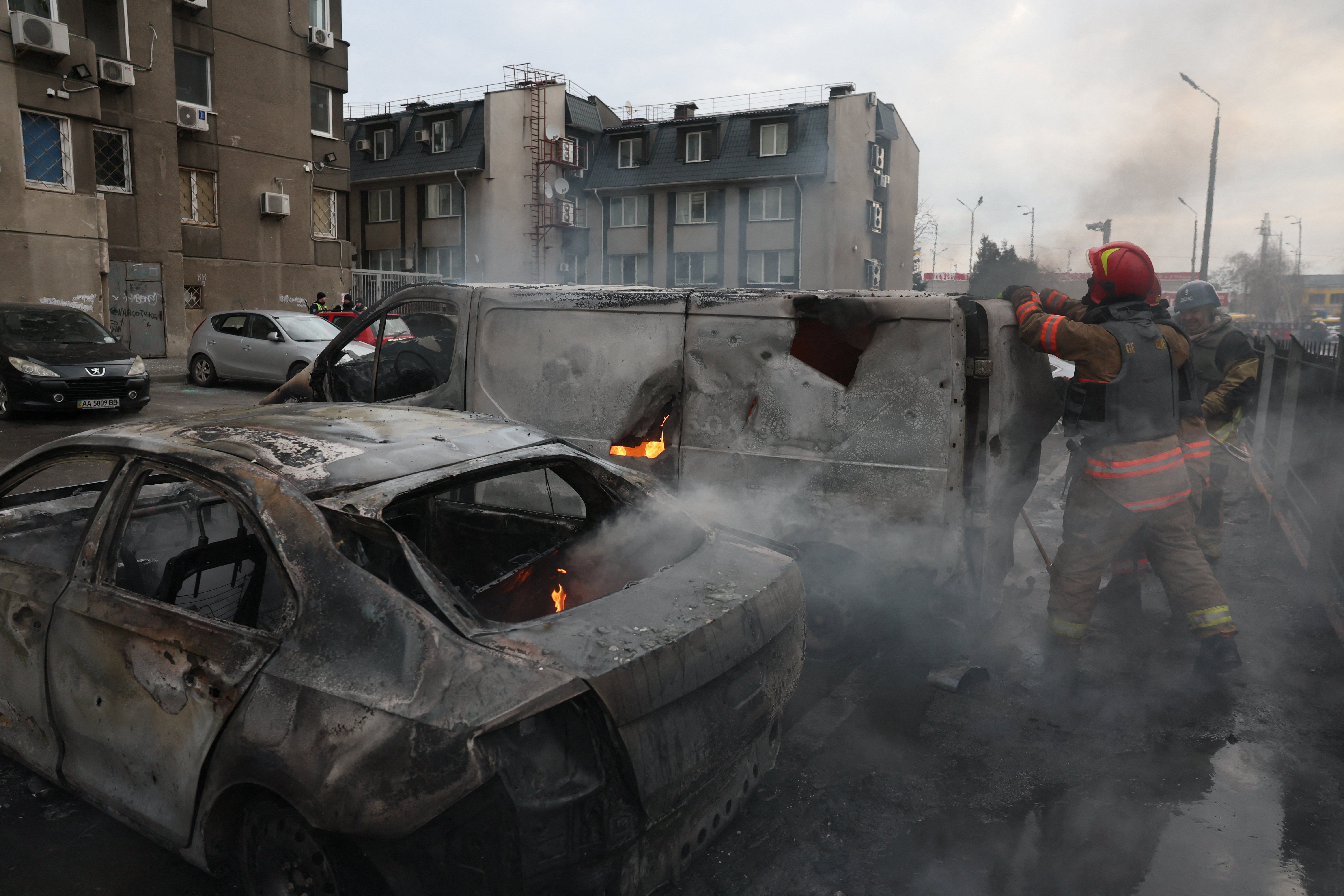 Emergency workers extinguish fire in vehicles at the site of a Russian missile strike, amid Russia?s attack on Ukraine, in Kyiv, Ukraine March 9, 2023.