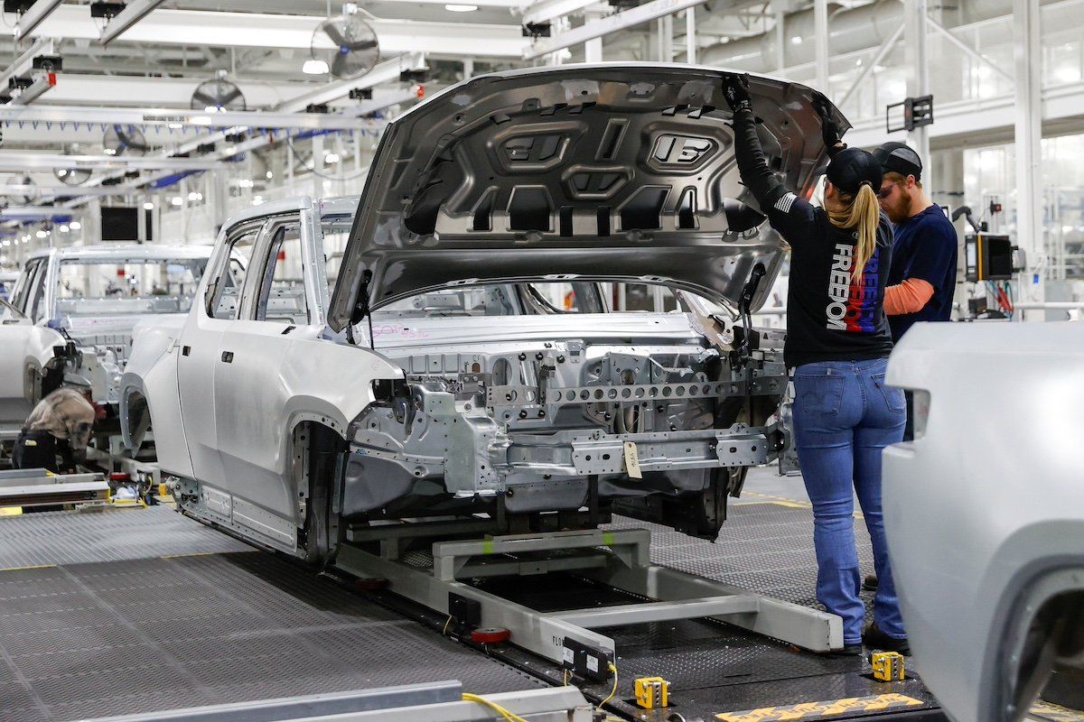 Employees work on an assembly line at startup Rivian Automotive's electric vehicle factory in Normal, Illinois, U.S. April 11, 2022.