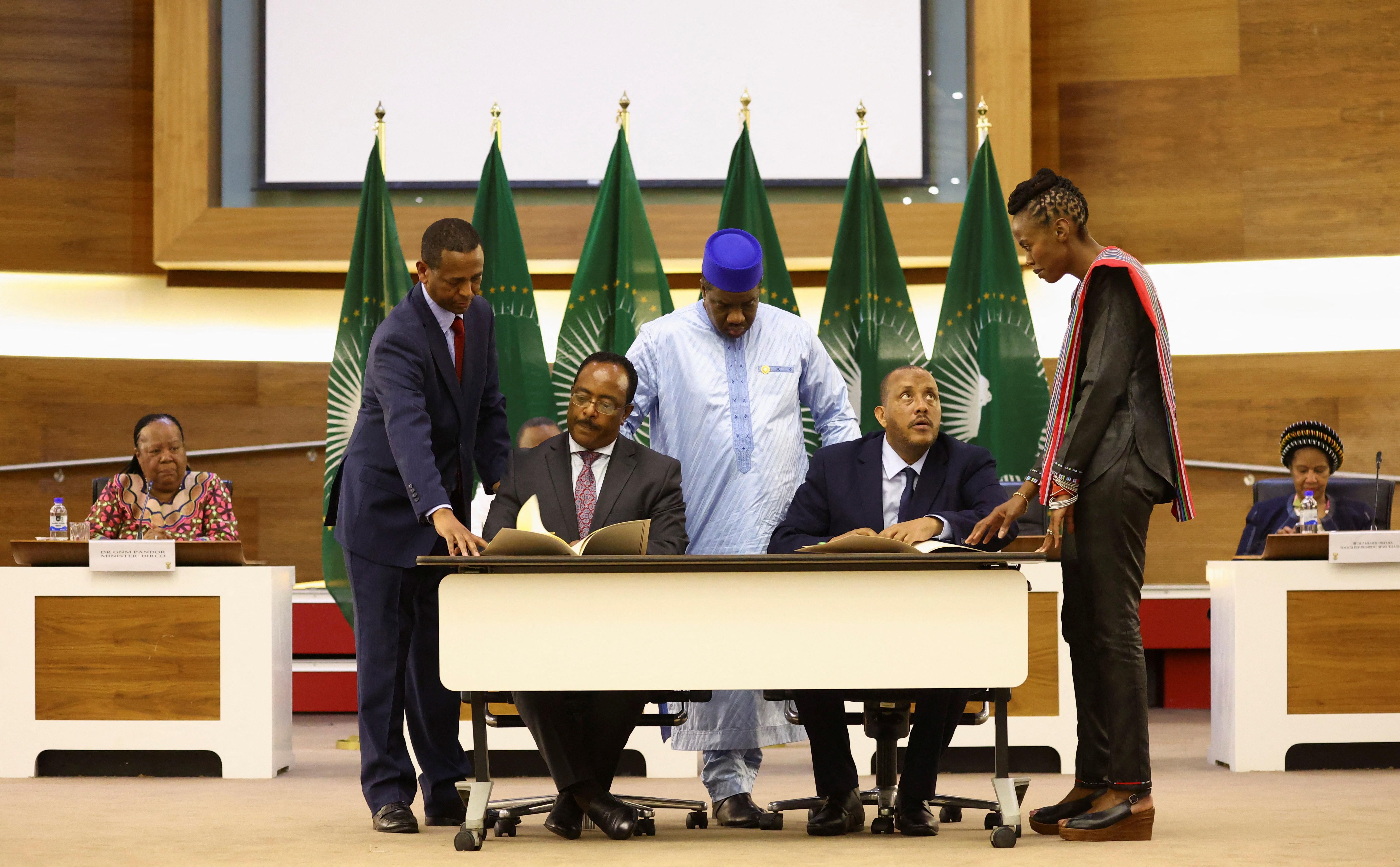 Ethiopian government representative Redwan Hussien and Tigray delegate Getachew Reda attend signing of the AU-led negotiations to resolve the conflict in northern Ethiopia. 