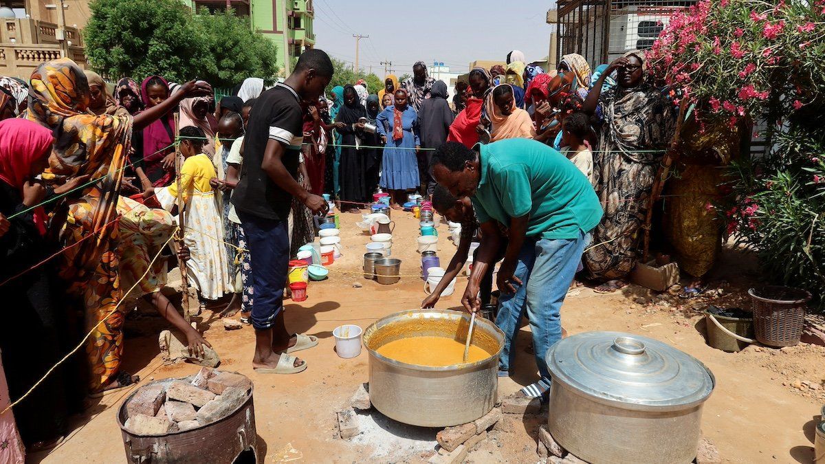 FILE PHOTO: A volunteer stirring food to be distributed to people in Omdurman, Sudan, September 3, 2023.