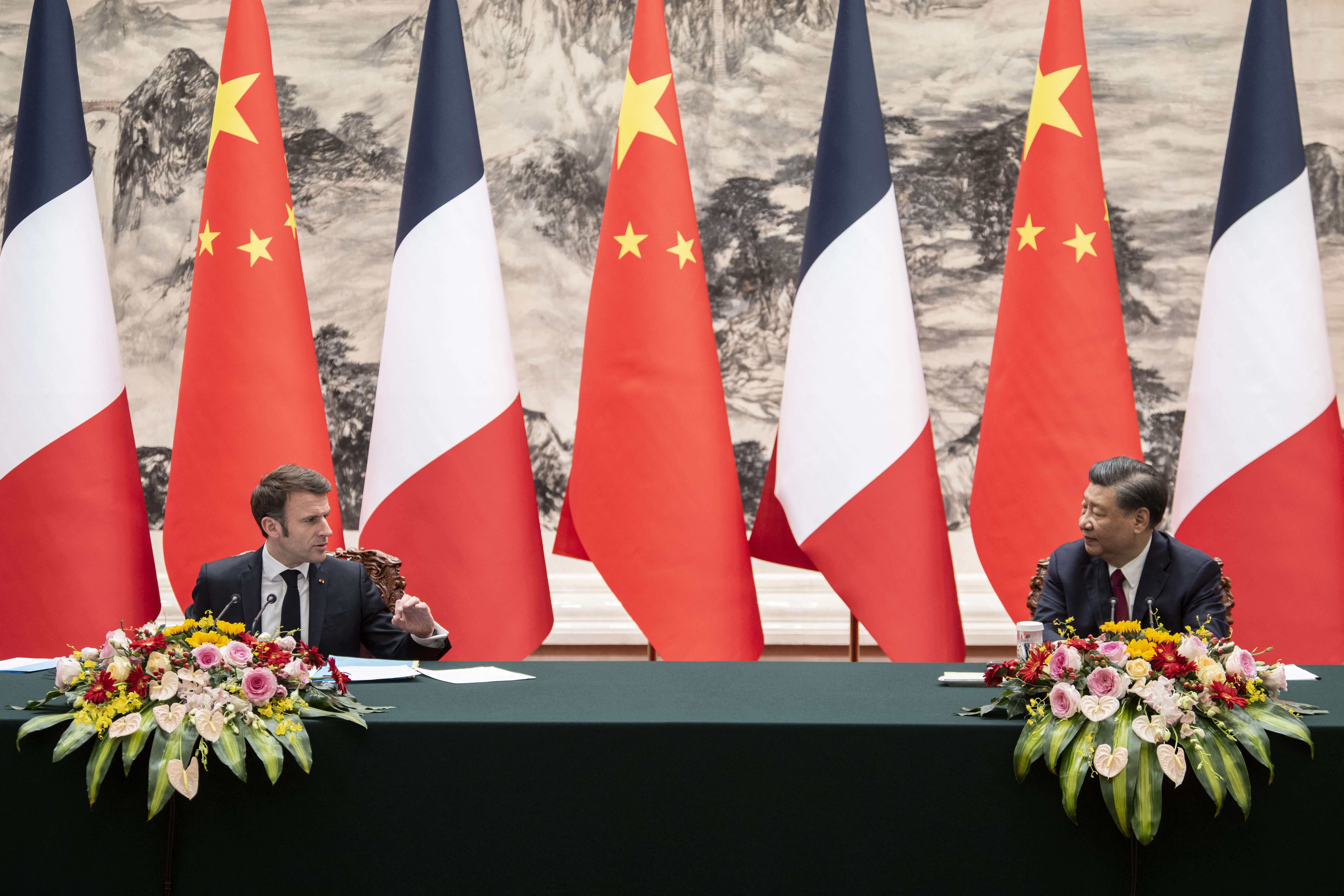 French President Emmanuel Macron and China’s President Xi Jinping gesture during a press conference in Beijing.