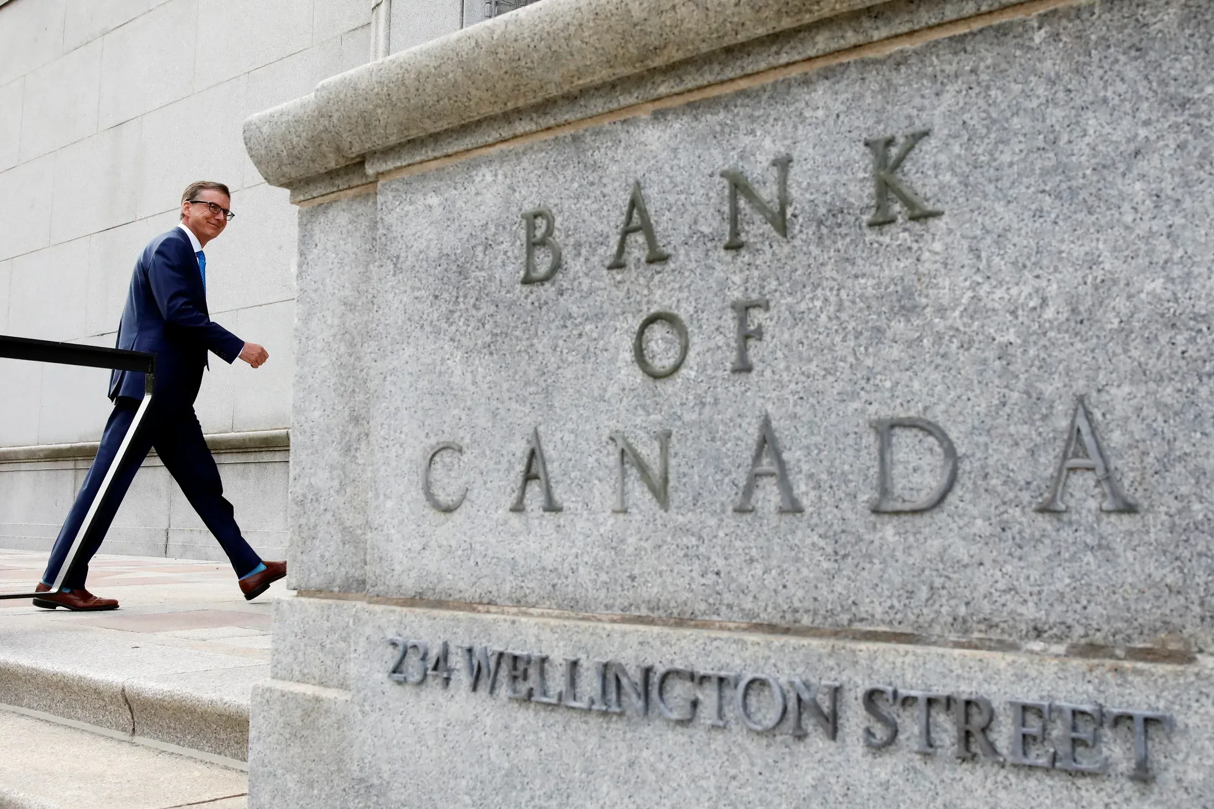 Gov. Tiff Macklem walks outside Bank of Canada building in Ottawa