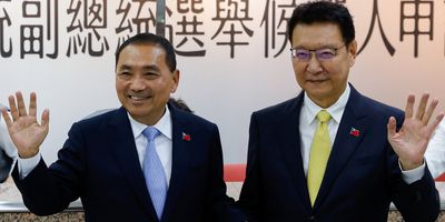 Hou Yu-ih, left, candidate for Taiwan's presidency from the main opposition Kuomintang Party, and Jaw Shaw-Kong, vice presidential candidate, wave at the Central Election Commission in Taipei on Nov. 24, 2023.