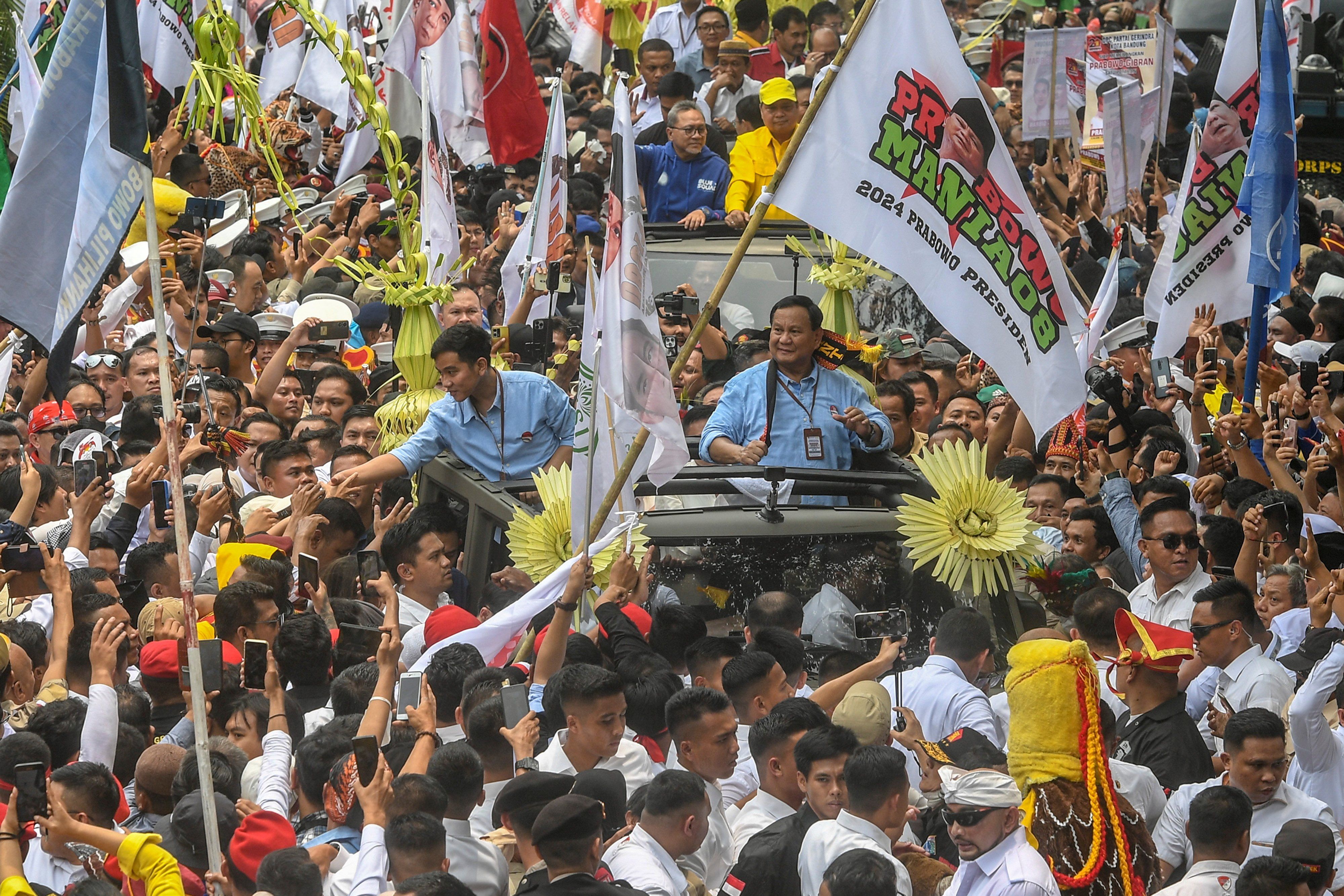 Indonesia's defence minister and presidential candidate, Prabowo Subianto, along with his running mate, Gibran Rakabuming Raka, who is the eldest son of Indonesian President Joko Widodo and Surakarta's Mayor, greet their supporters as they arrive at the election commission headquarters for registering themselves for next year's presidential election, in Jakarta, Indonesia, October 25, 2023