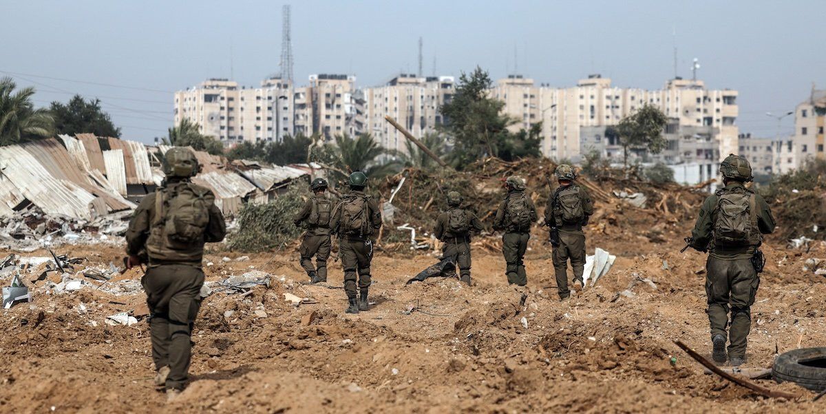 Israeli soldiers walk as they operate, amid the ongoing conflict between Israel and the Palestinian Islamist group Hamas, in Gaza, January 8, 2024.