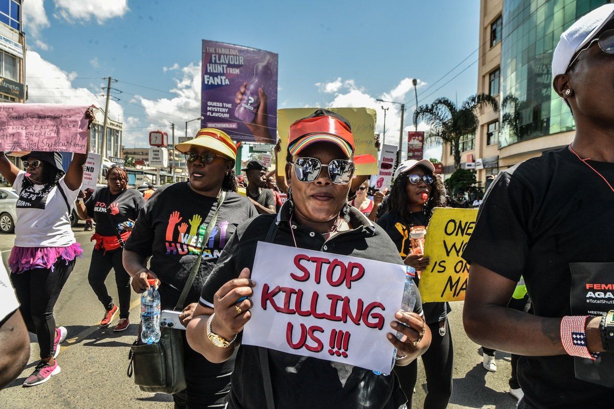 ​Protesters march while carrying placards and chanting slogans in the "Feminists March Against Femicide" in Kenya. 