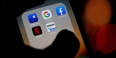 Logos of mobile apps, Google, Amazon, Facebook, Apple, and Netflix displayed on a screen.