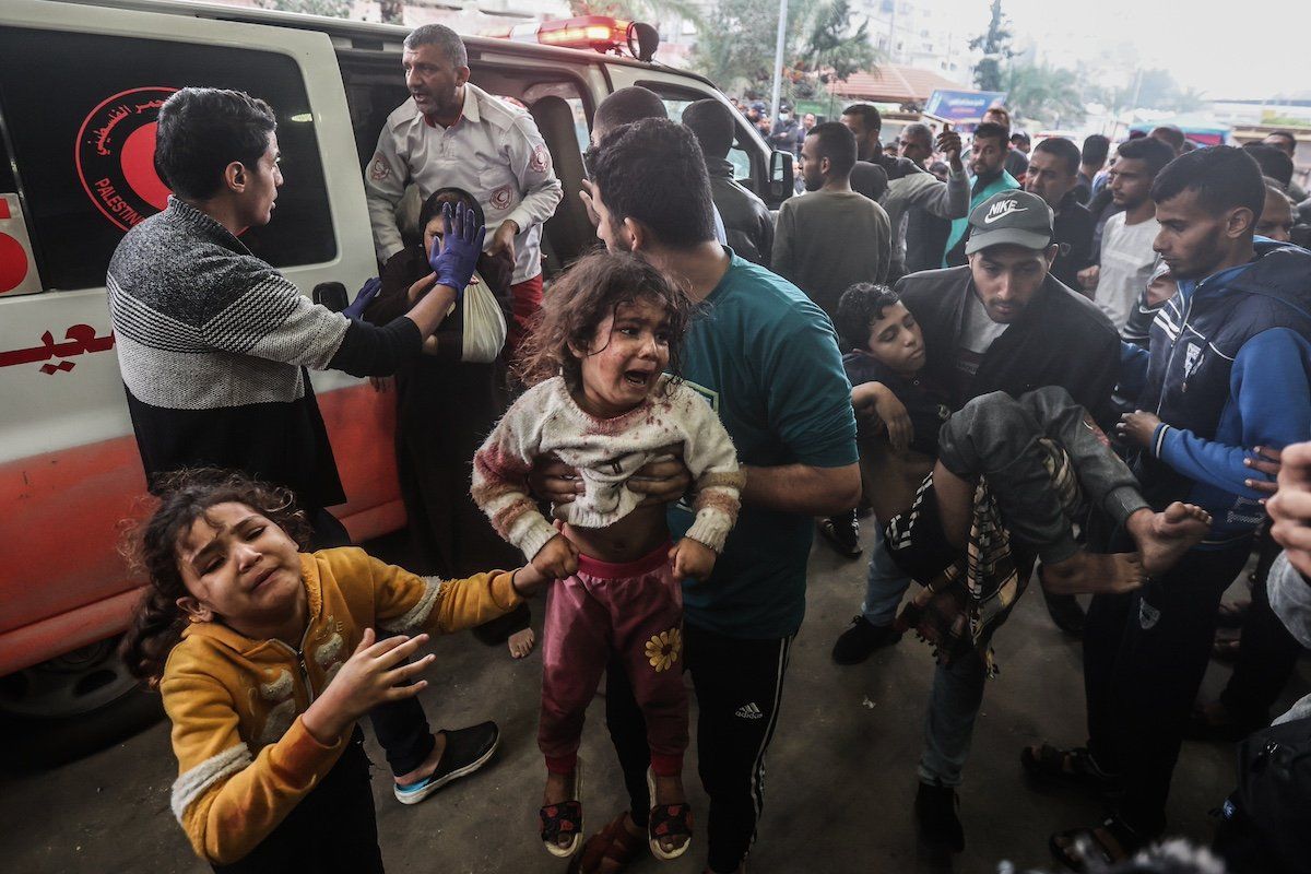 Palestinians, injured during an Israeli bombing, arrive at the Nasser Hospital.