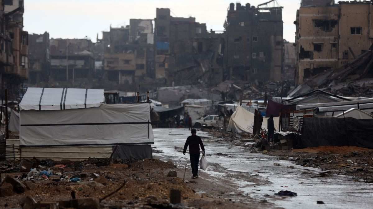 ​Palestinians walk in the rain at a makeshift camp in Gaza City, on Nov. 25, 2025.