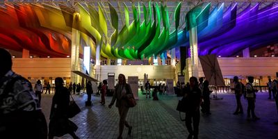 Participants enter the Dubai Exhibition Centre during the COP28, UN Climate Change Conference.