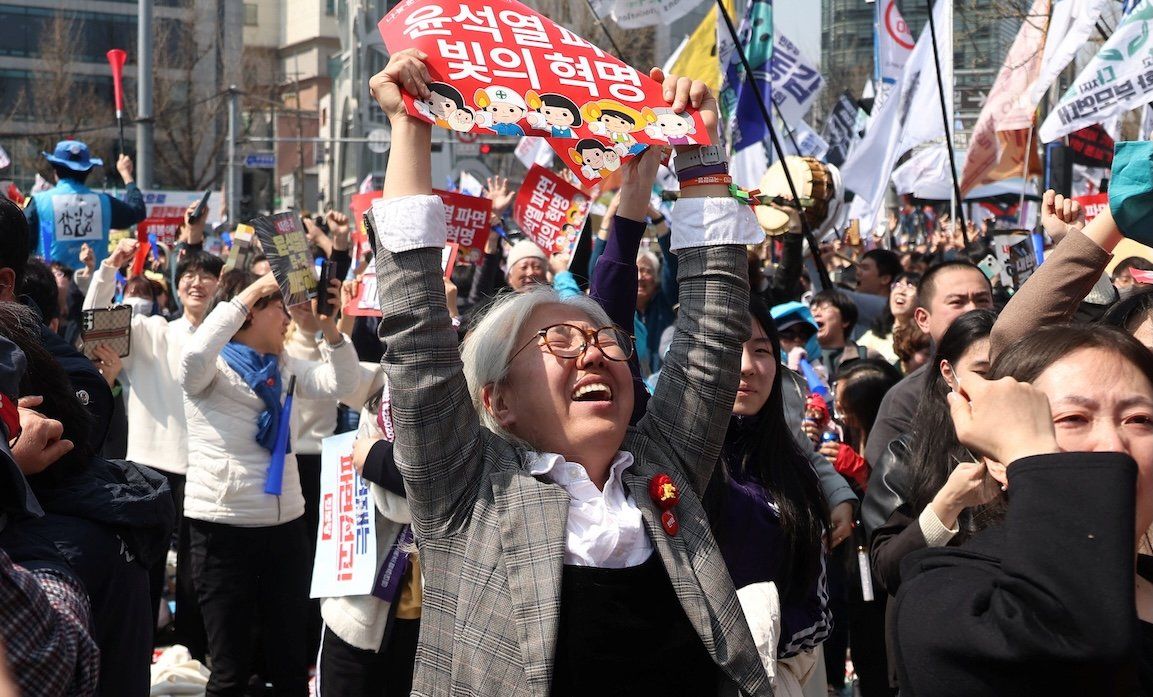 ​People celebrate after President Yoon Suk-yeol's impeachment was accepted, near the Constitutional Court in Seoul, South Korea, on April 4, 2025. 