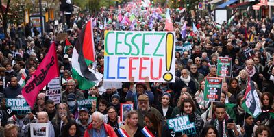 People hold a placard in a demonstration demanding an immediate cease-fire in Gaza, in Paris, France, on Nov. 11, 2023.