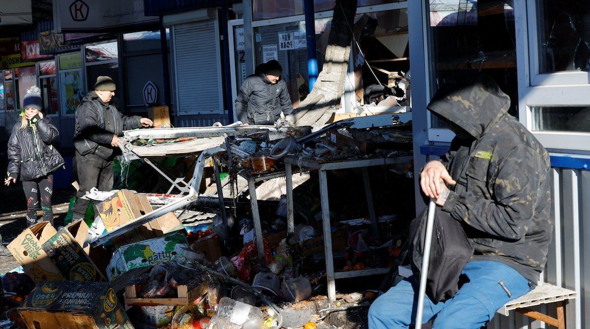People remove debris at a food market following, what local Russian-installed authorities say, was a Ukrainian military strike in the course of Russia-Ukraine conflict in Donetsk, Russian-controlled Ukraine, January 21, 2024.
