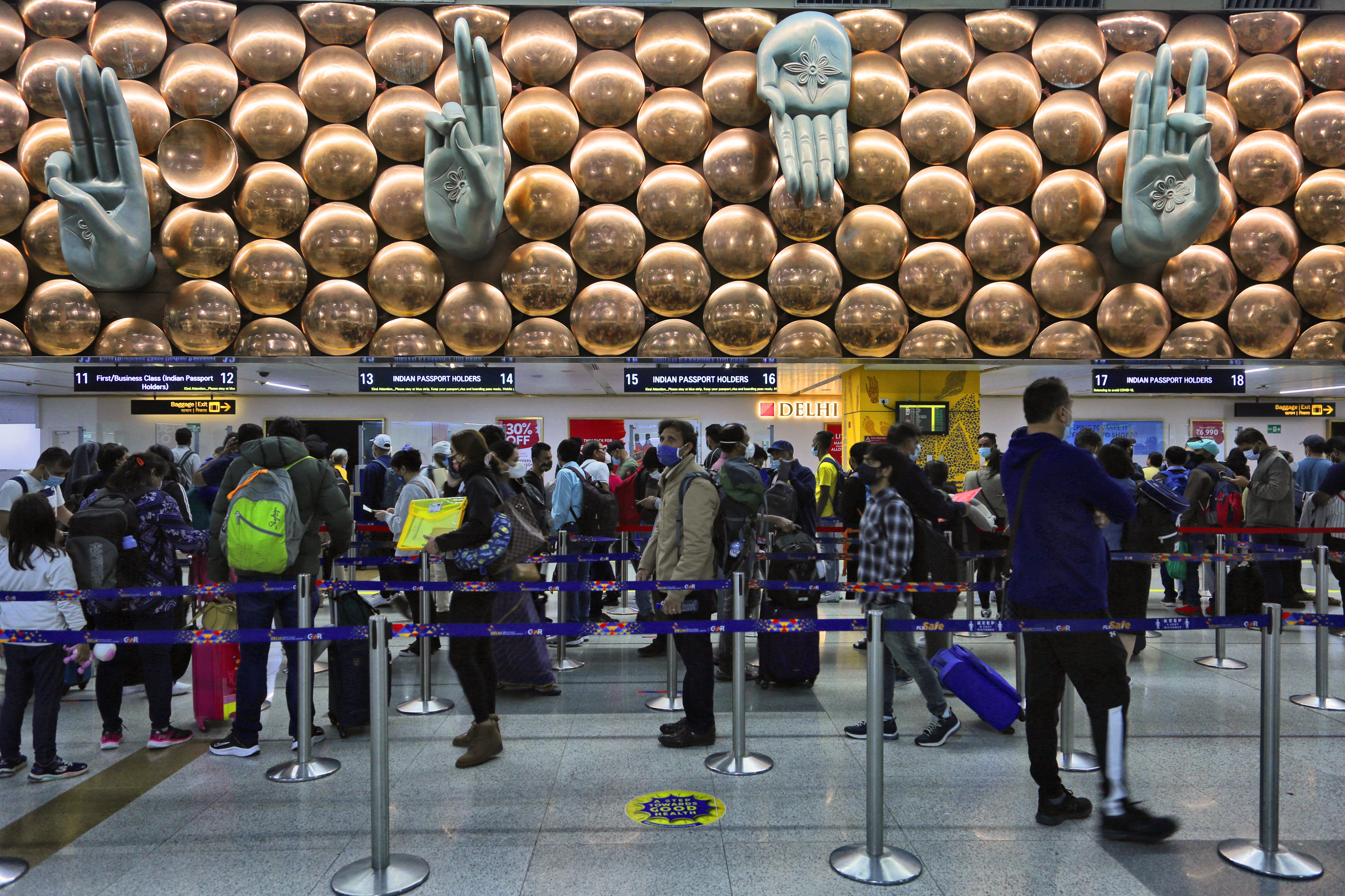 People waiting at customs clearance area at Indira Gandhi International Airport in Delhi, India. 