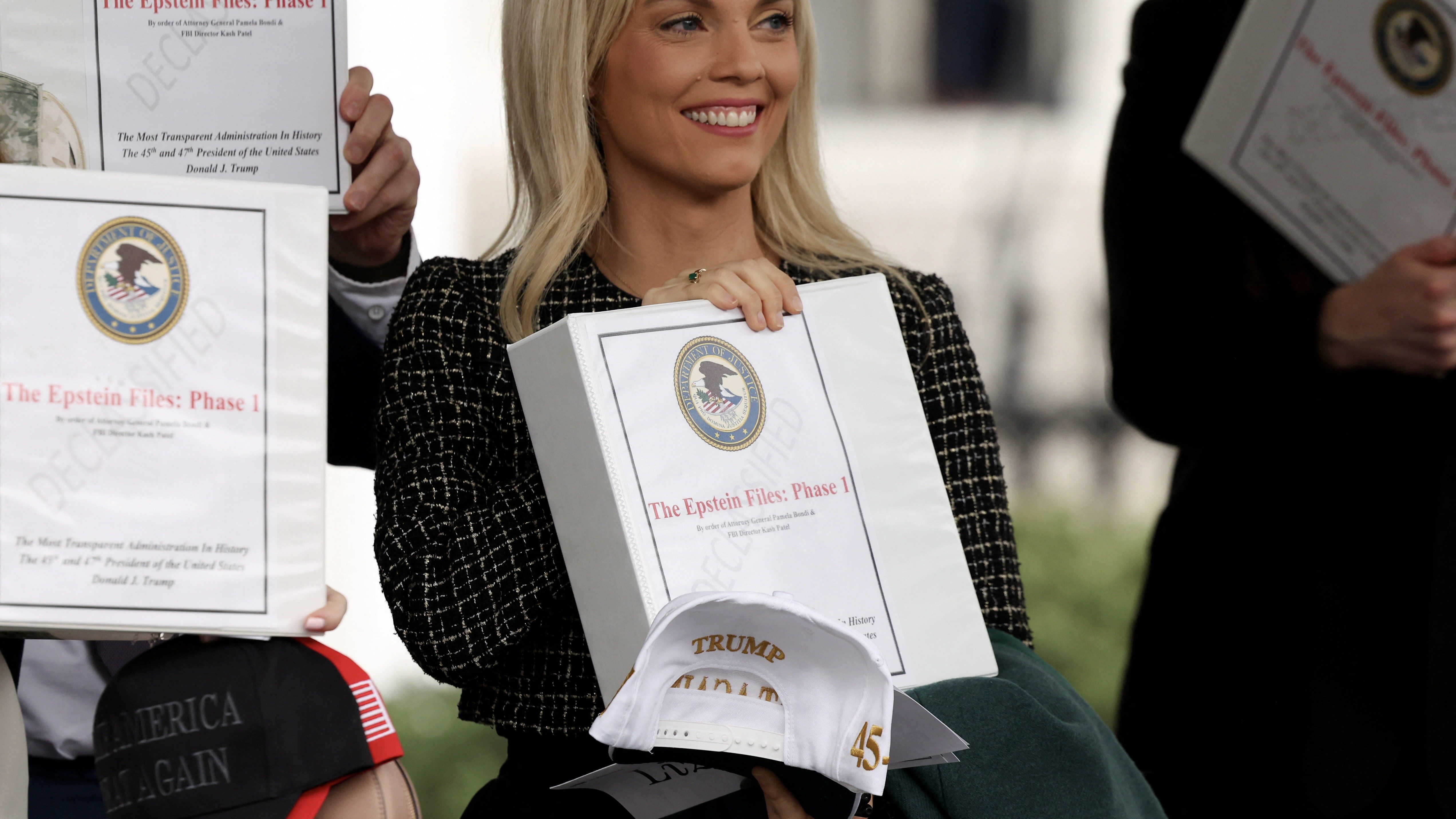 People walk out of the West Wing of the White House with "The Epstein Files: Phase 1" binders, in Washington, D.C., U.S., February 27, 2025. 