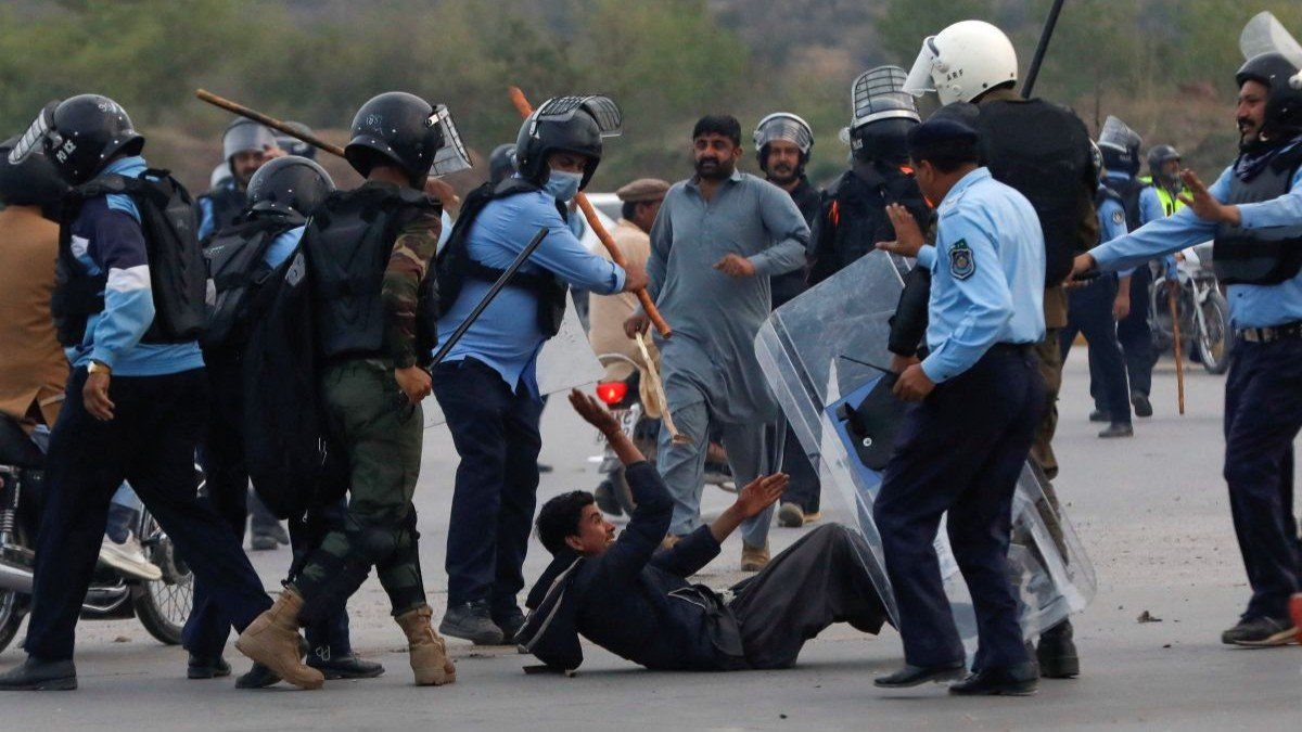 Police officers clash with a supporter of former Pakistani Prime Minister Imran Khan during a protest outside Federal Judicial Complex in Islamabad, Pakistan March 18, 2023. 