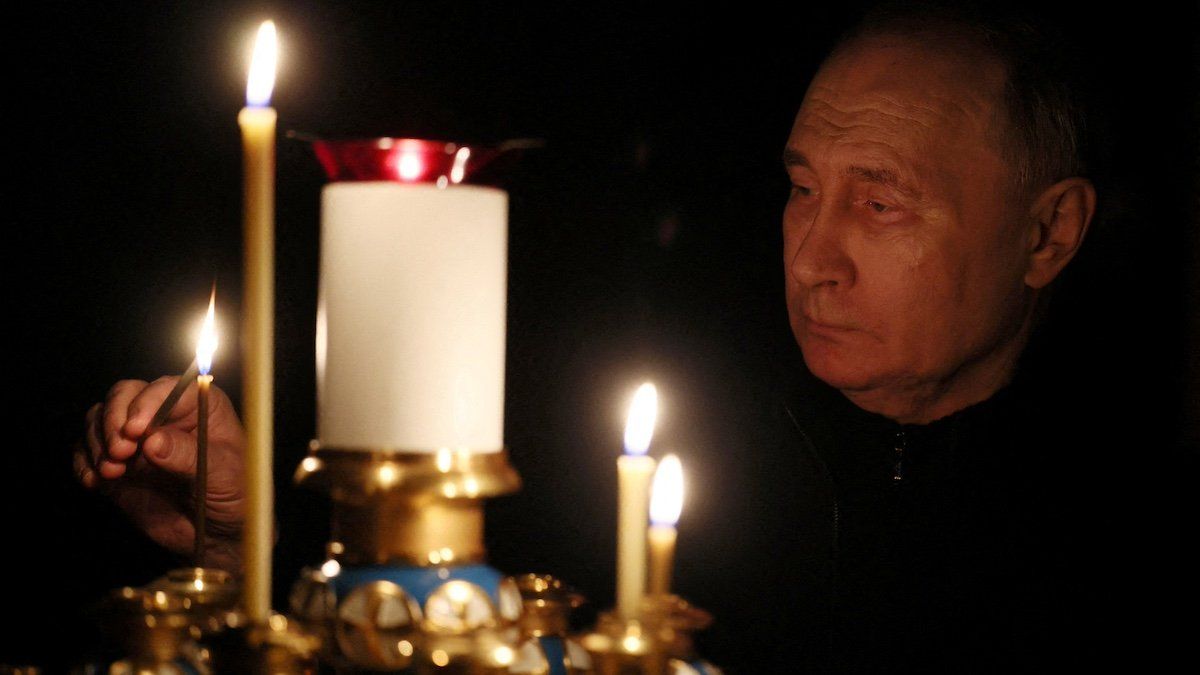 Russian President Vladimir Putin lights a candle in memory of the victims of the Crocus City Hall attack, on the day of national mourning in a church at the Novo-Ogaryovo state residence outside Moscow, Russia March 24, 2024. 